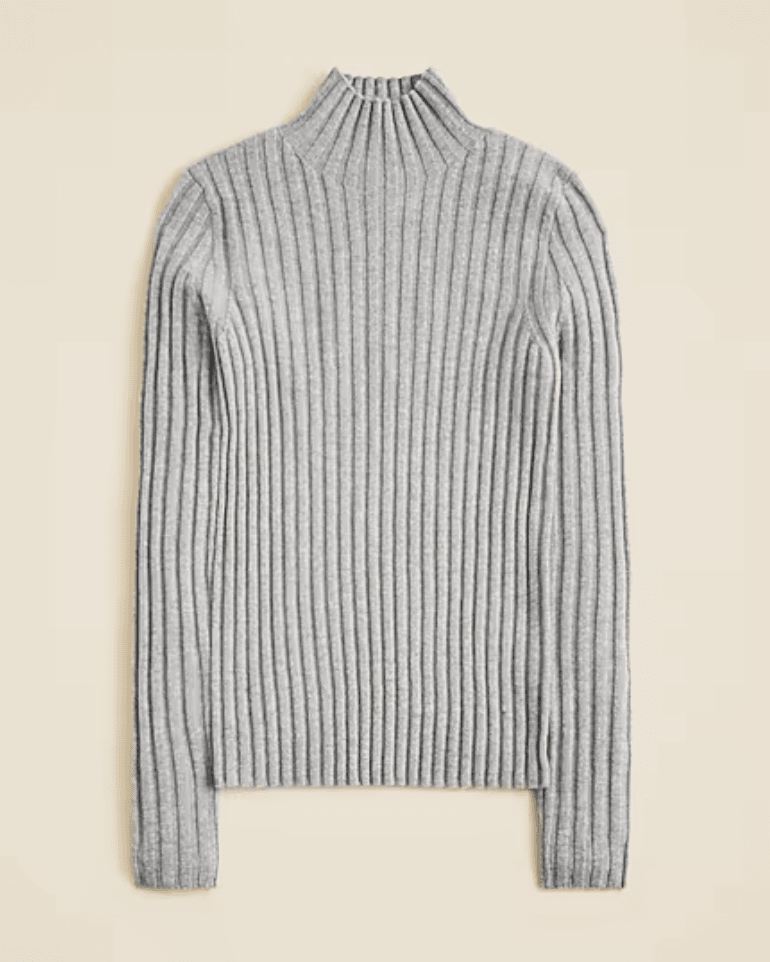 A light gray, long-sleeved, ribbed knit sweater with a high mock neckline, laid flat on a neutral background, by McGee & Co.